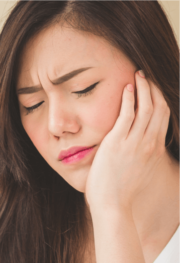 Image of a model girl feeling pain of her teeth by holding her left side of the face
