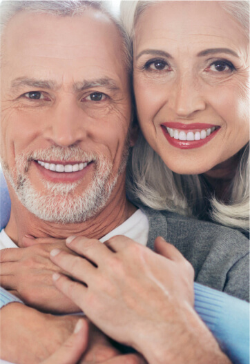 Image of smiling elder woman holding an elder smiling man from back