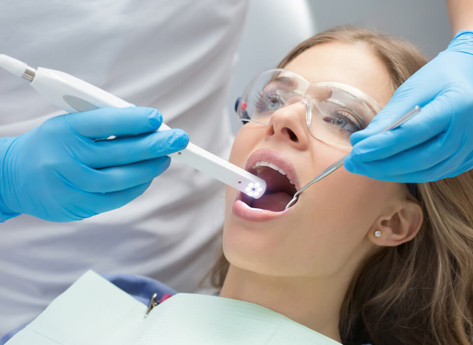 Image of a lady patient being undergone a dental treatment