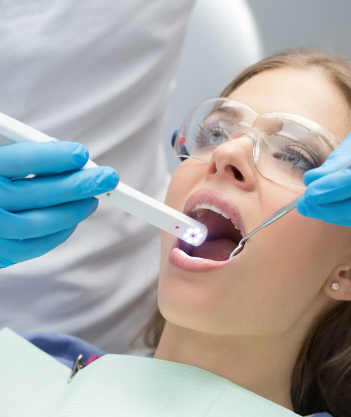 Image of a lady patient being undergone a dental treatment